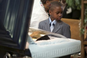 child at funeral crop