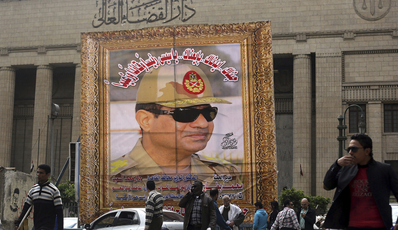 People walk past huge banner for Egypt's army chief, Field Marshal al-Sisi in front of High Court of Justice in downtown Cairo