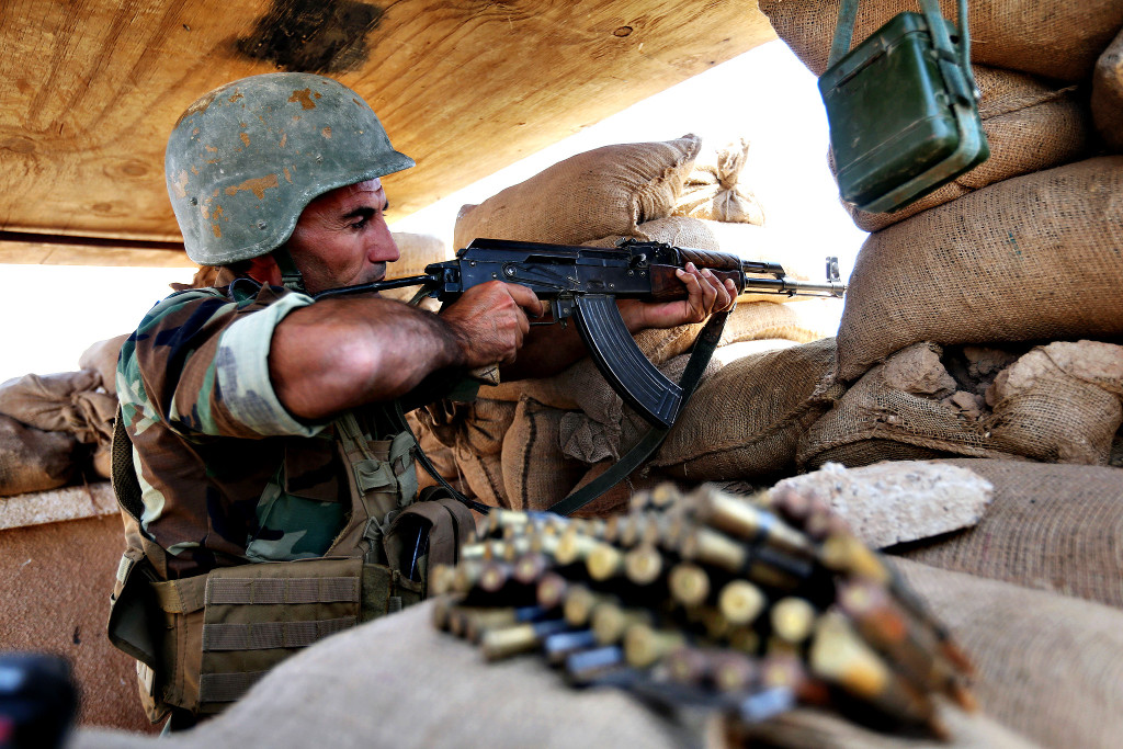 A Kurdish peshmerga fighter takes his position on the front line